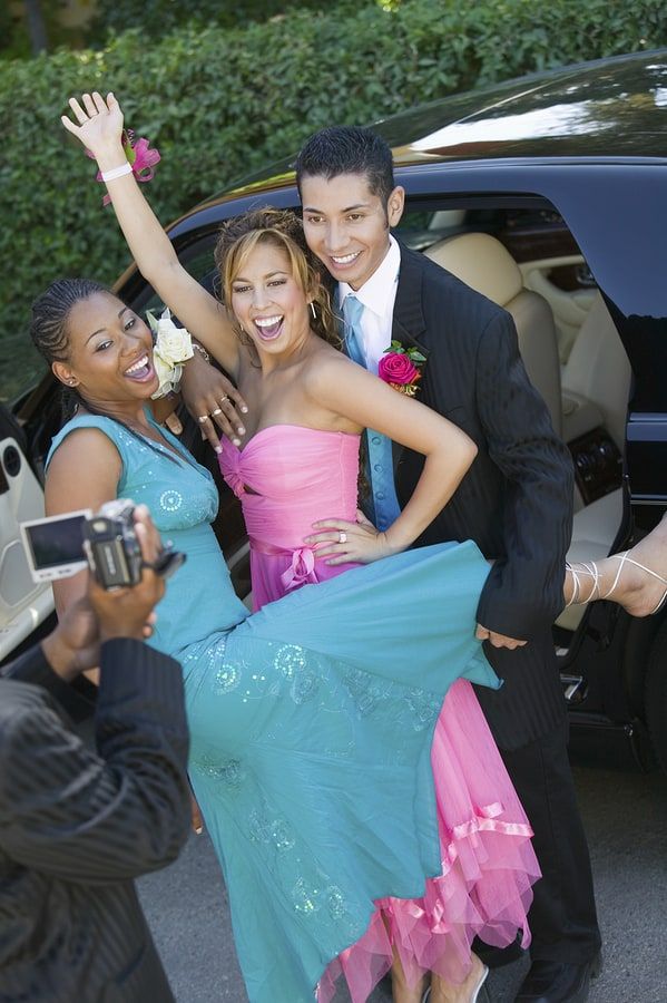 Teenagers posing for pictures for prom